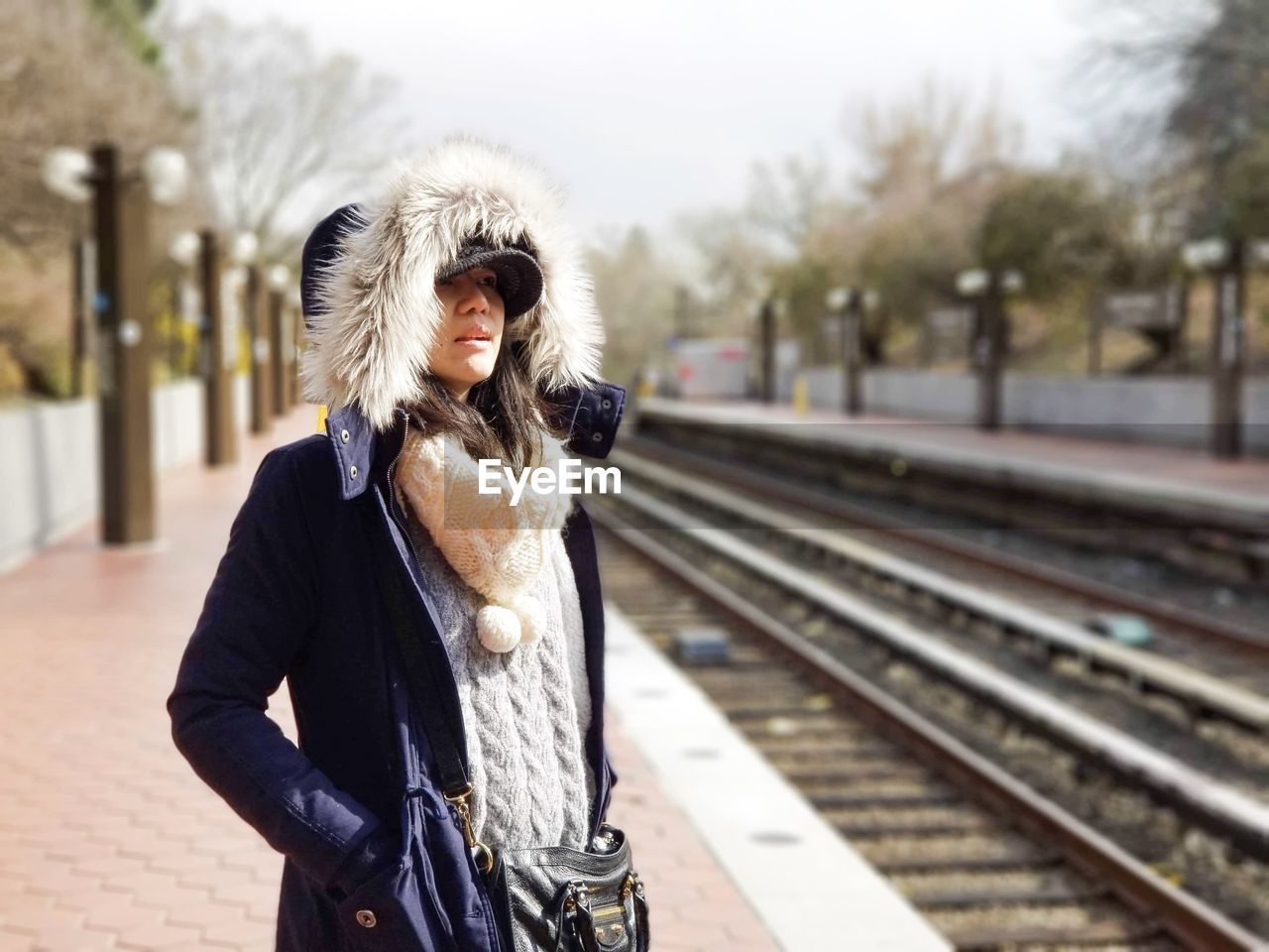 Woman standing on railroad station platform