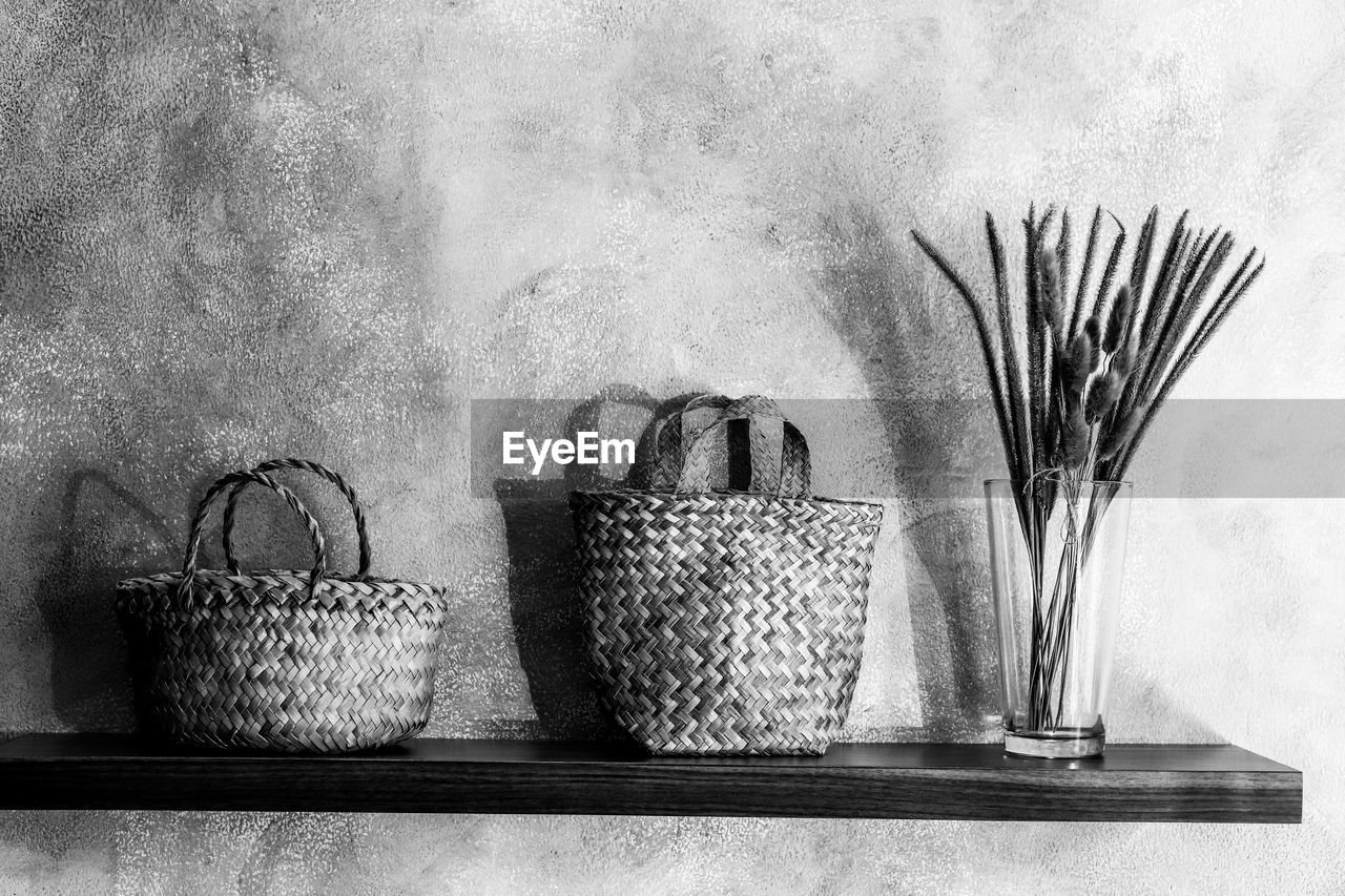 Potted plant in basket on table