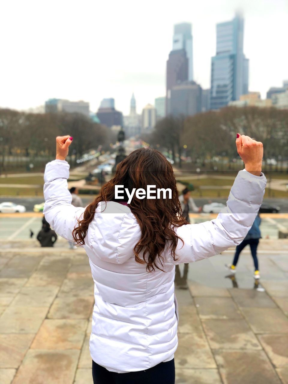 REAR VIEW OF WOMEN STANDING AT PARK