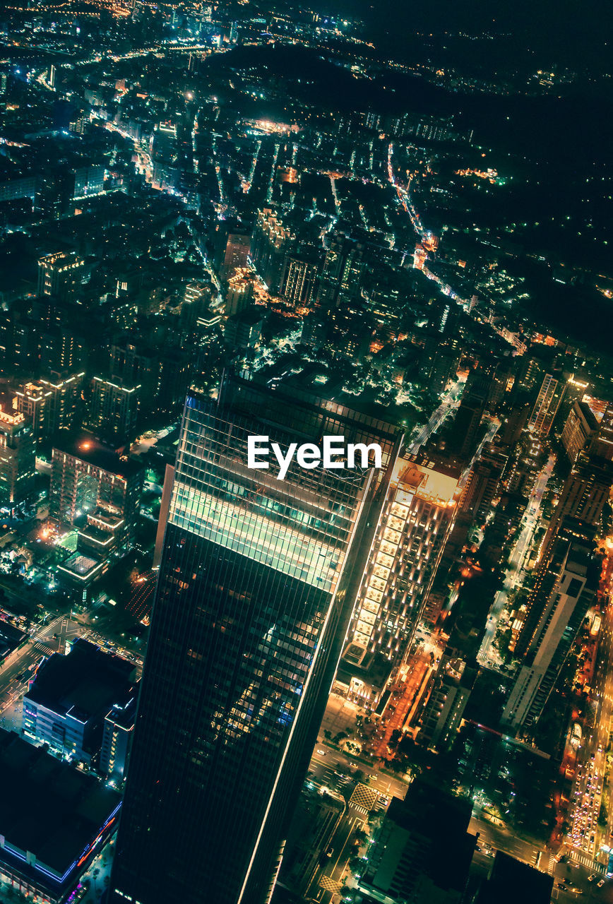 High angle view of illuminated buildings in city at night