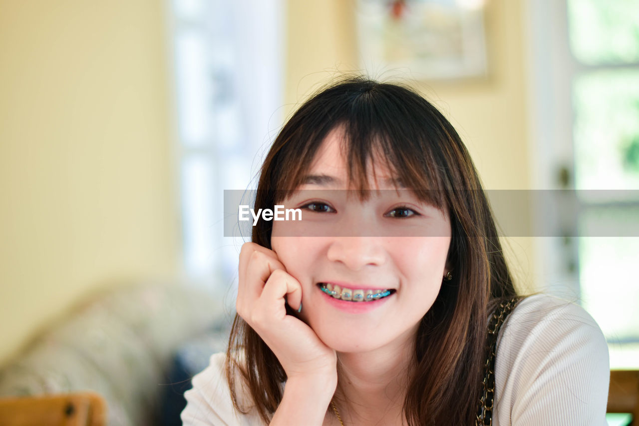 close-up portrait of young woman at home