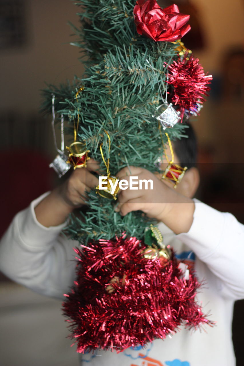 Boy holding christmas decoration