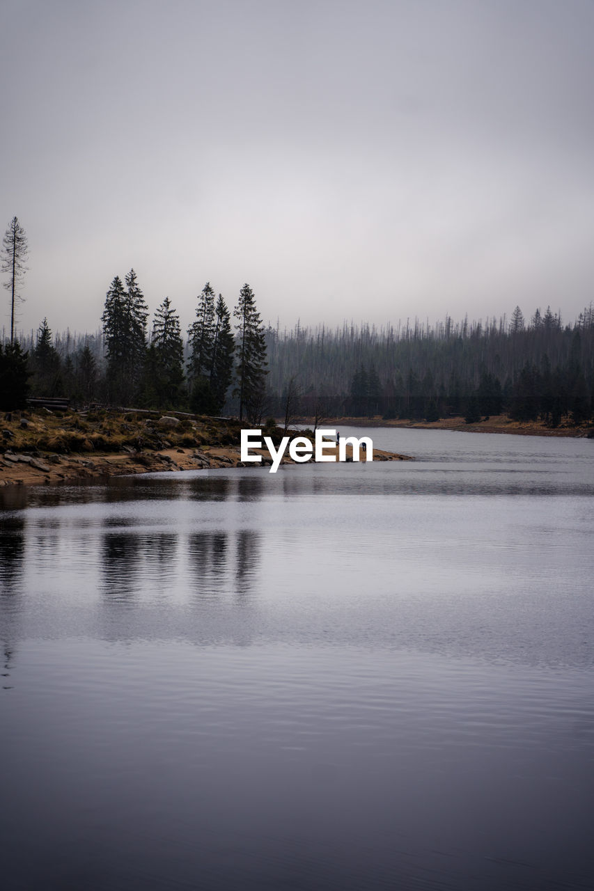 scenic view of lake against sky during sunset