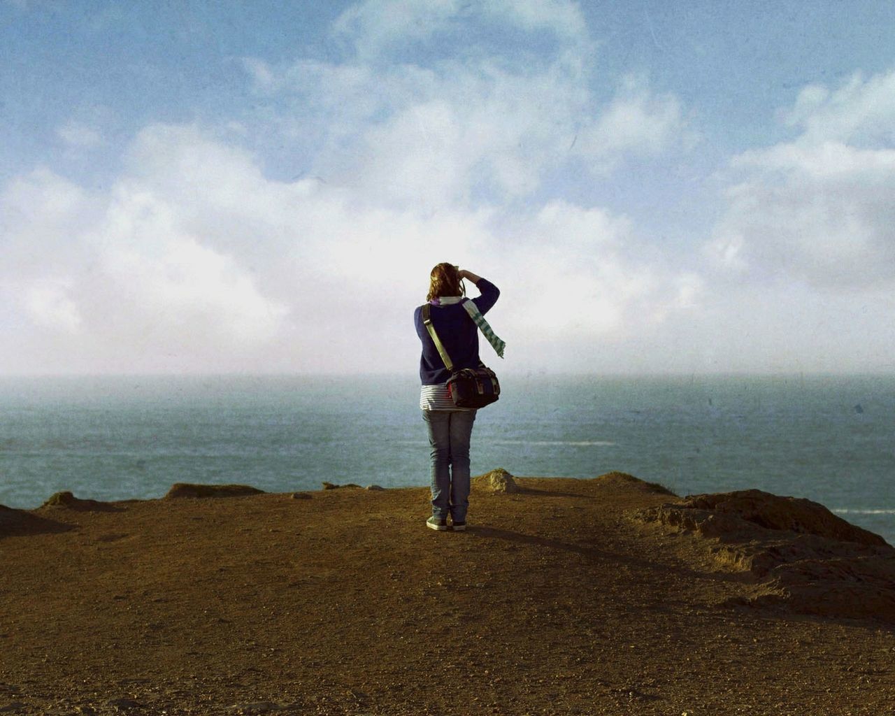 Rear view of woman standing against sea