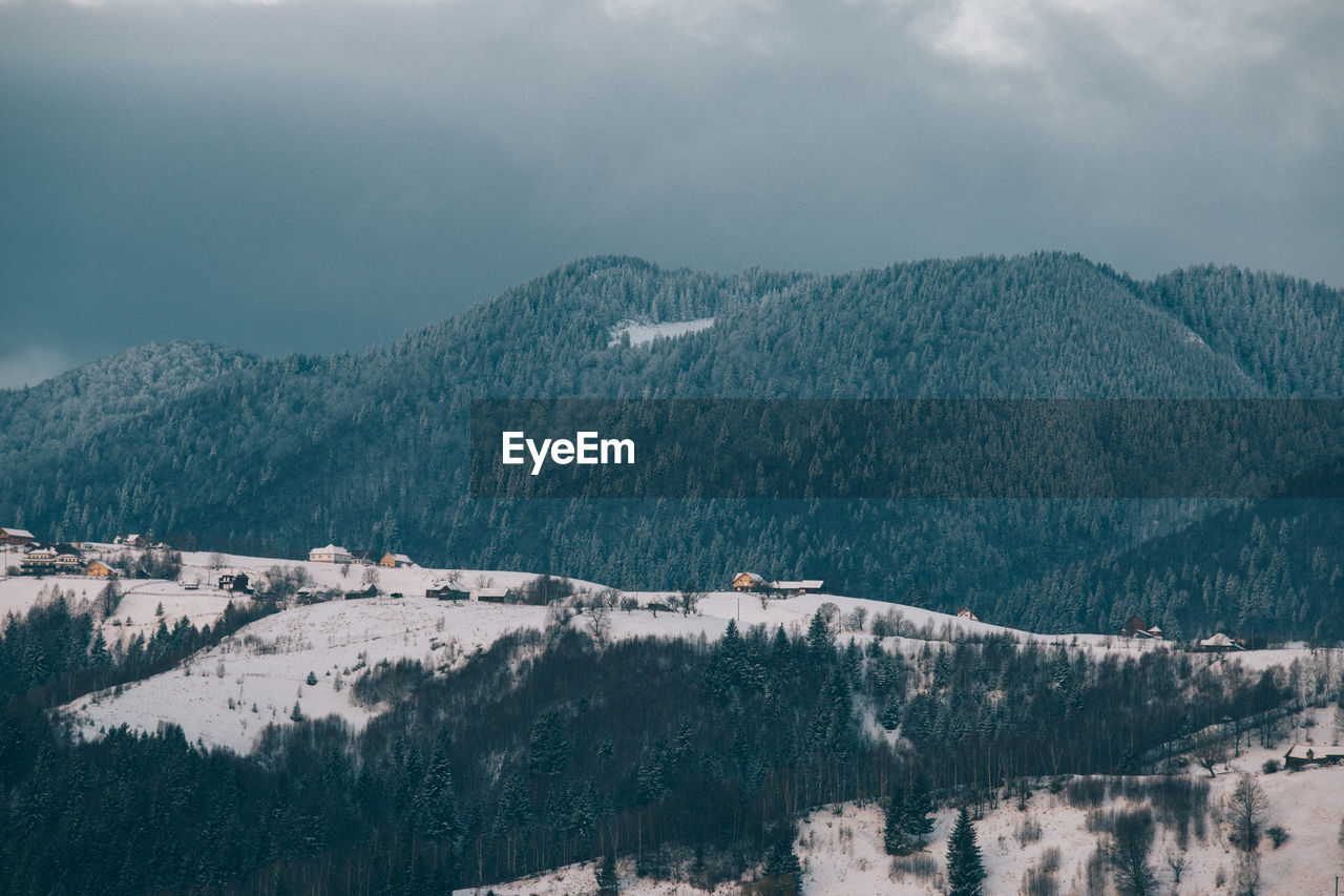 Scenic view of mountains against sky during winter