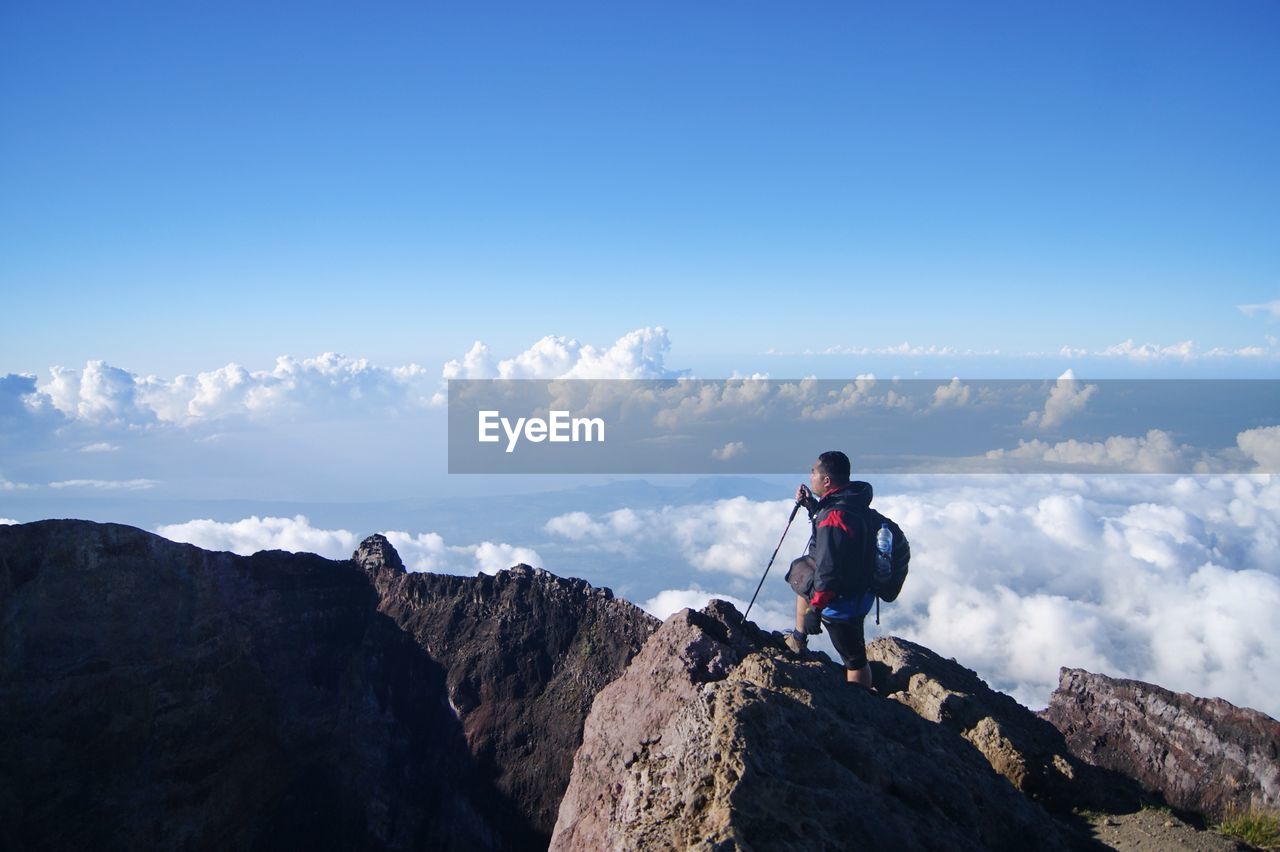 Man standing on rock against mountain