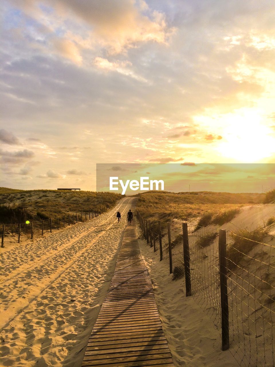 Scenic view of road against sunset close to the ocean.