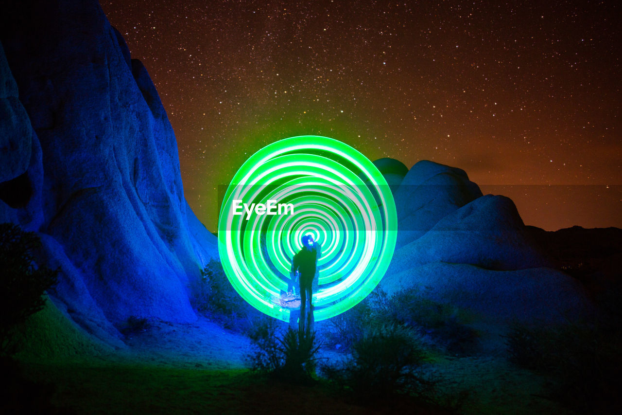 Man making green portal in desert