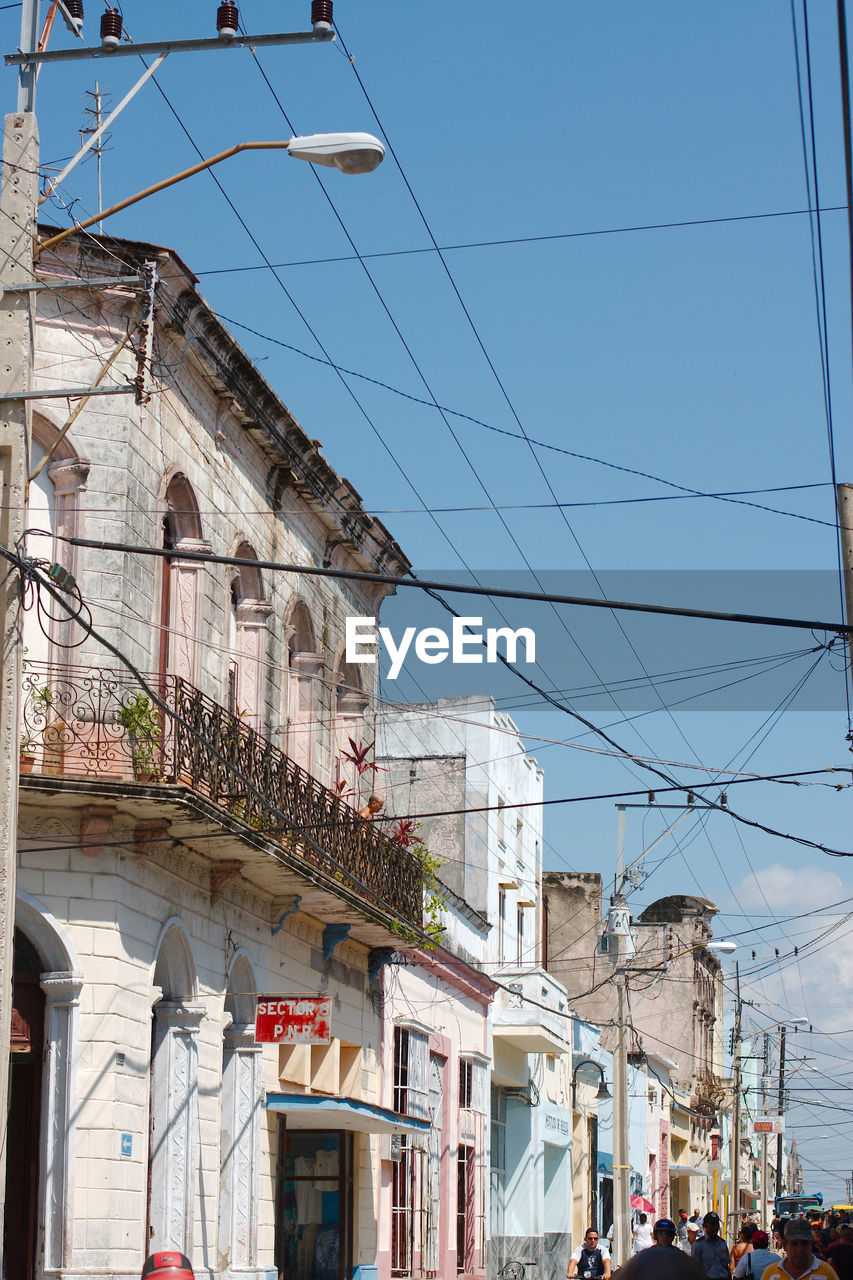 Residential street in camaguey, cuba. an excessof power lines.