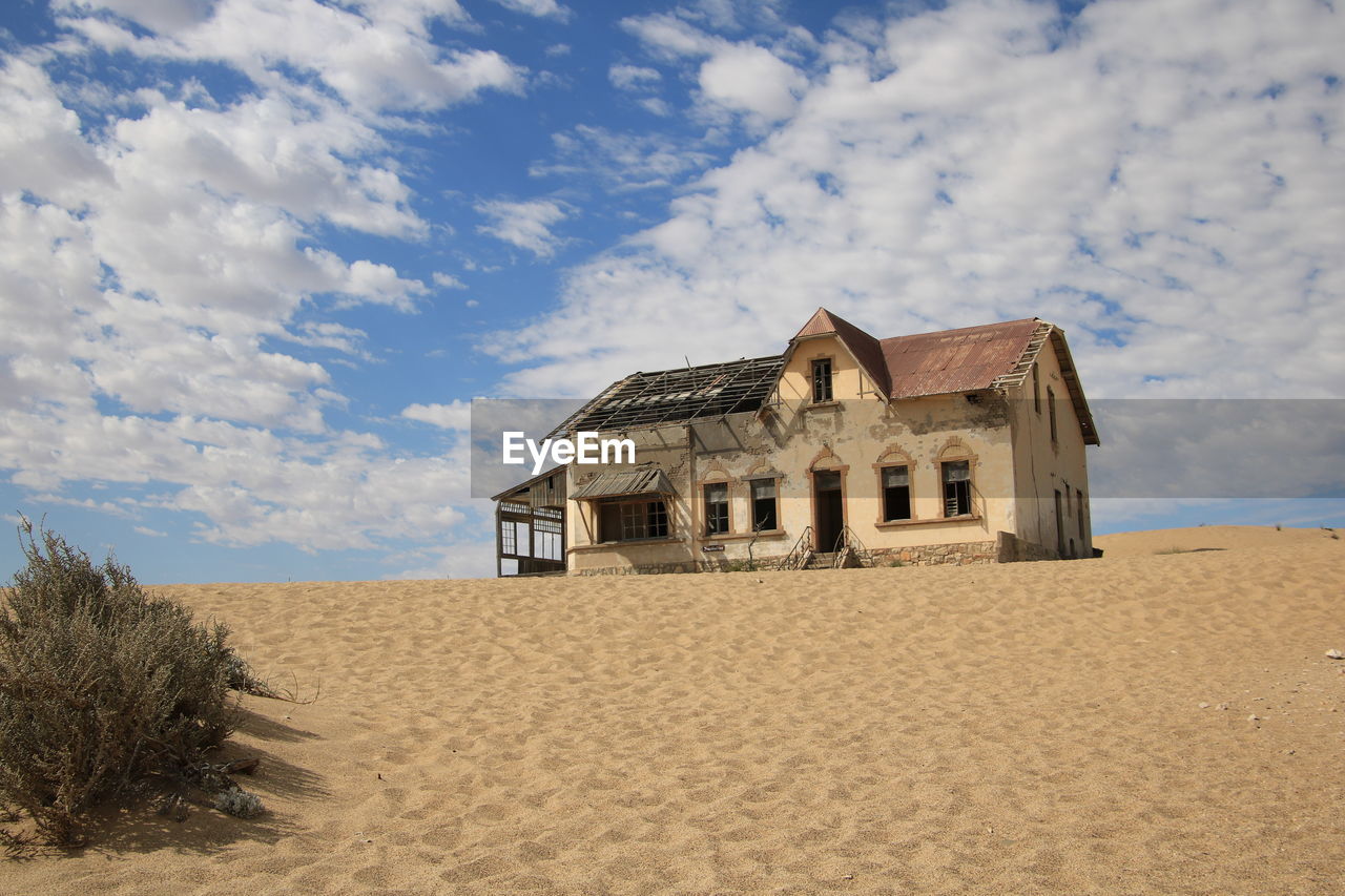 House on beach against sky