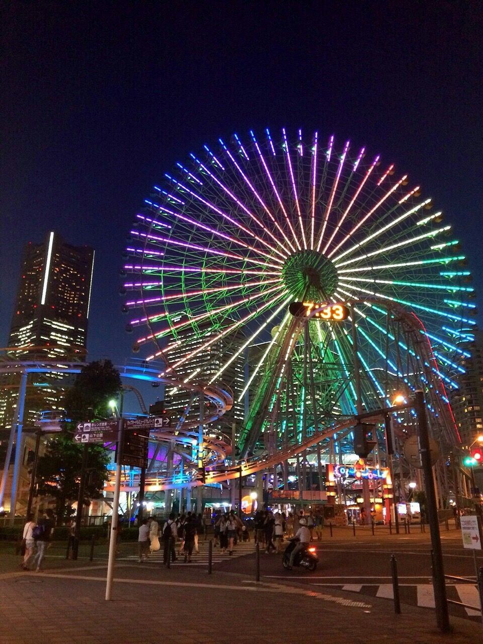 LOW ANGLE VIEW OF ILLUMINATED FERRIS WHEEL IN CITY