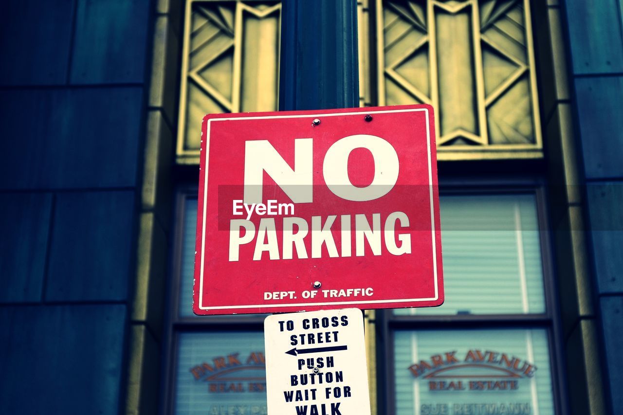 Low angle view of no parking sign outside building