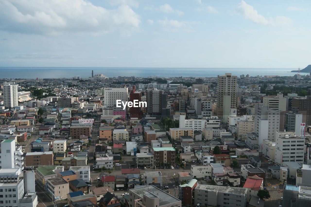 High angle view of buildings in city against sky