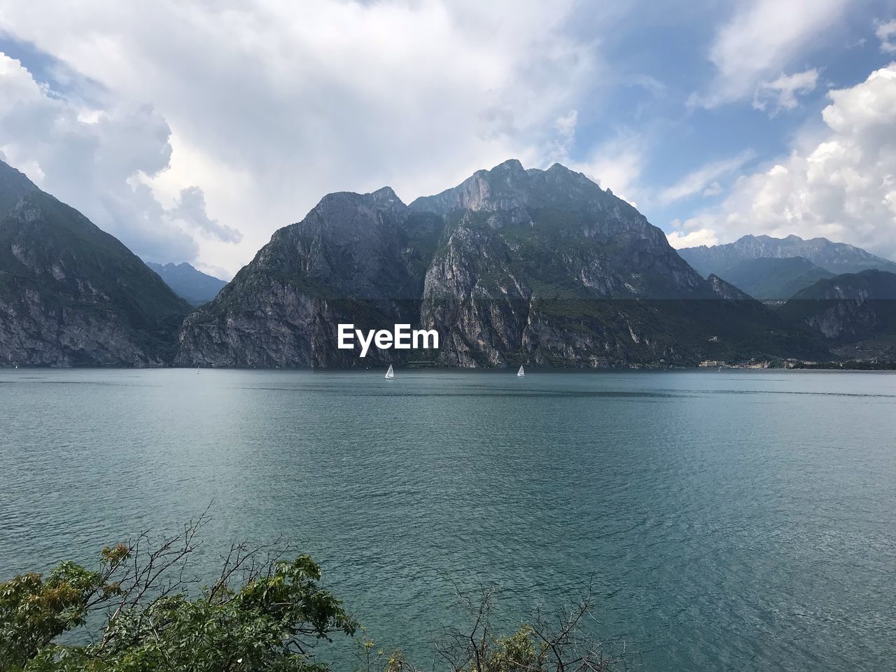 Scenic view of sea and mountains against sky