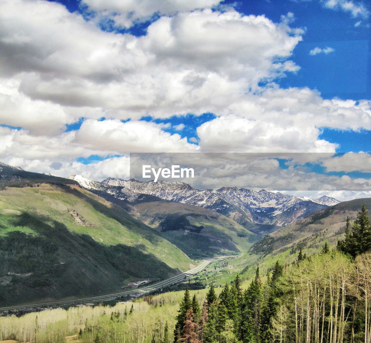 High angle view of countryside landscape against clouds