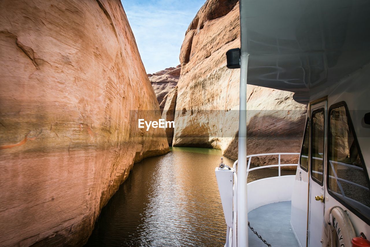 Cropped boat moving on lake powell amidst rocky mountains at rainbow bridge national monument