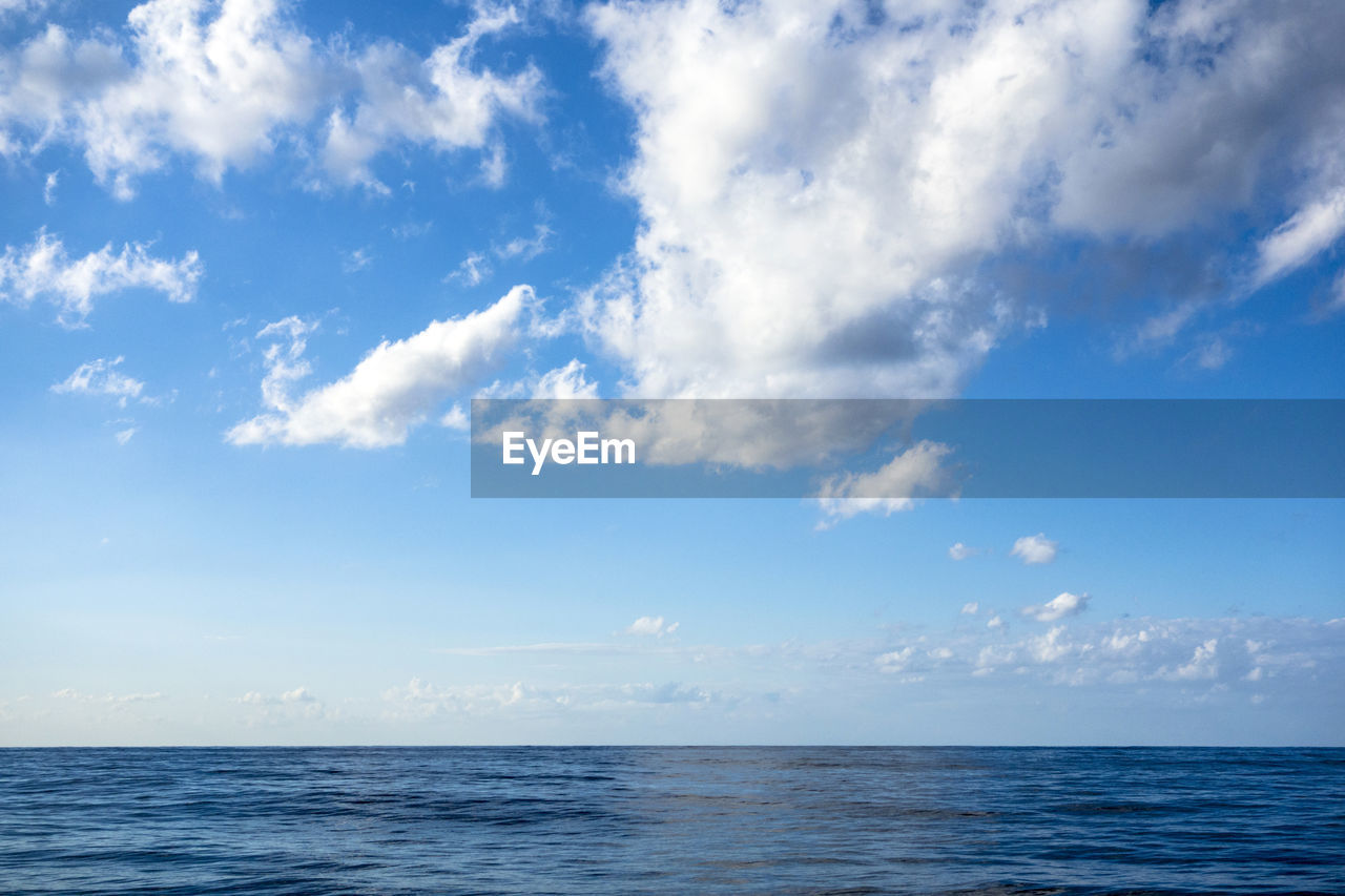 Scenic view of sea against blue sky