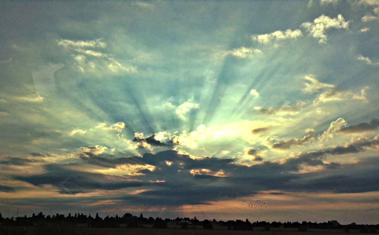 Dramatic sky over landscape during sunset