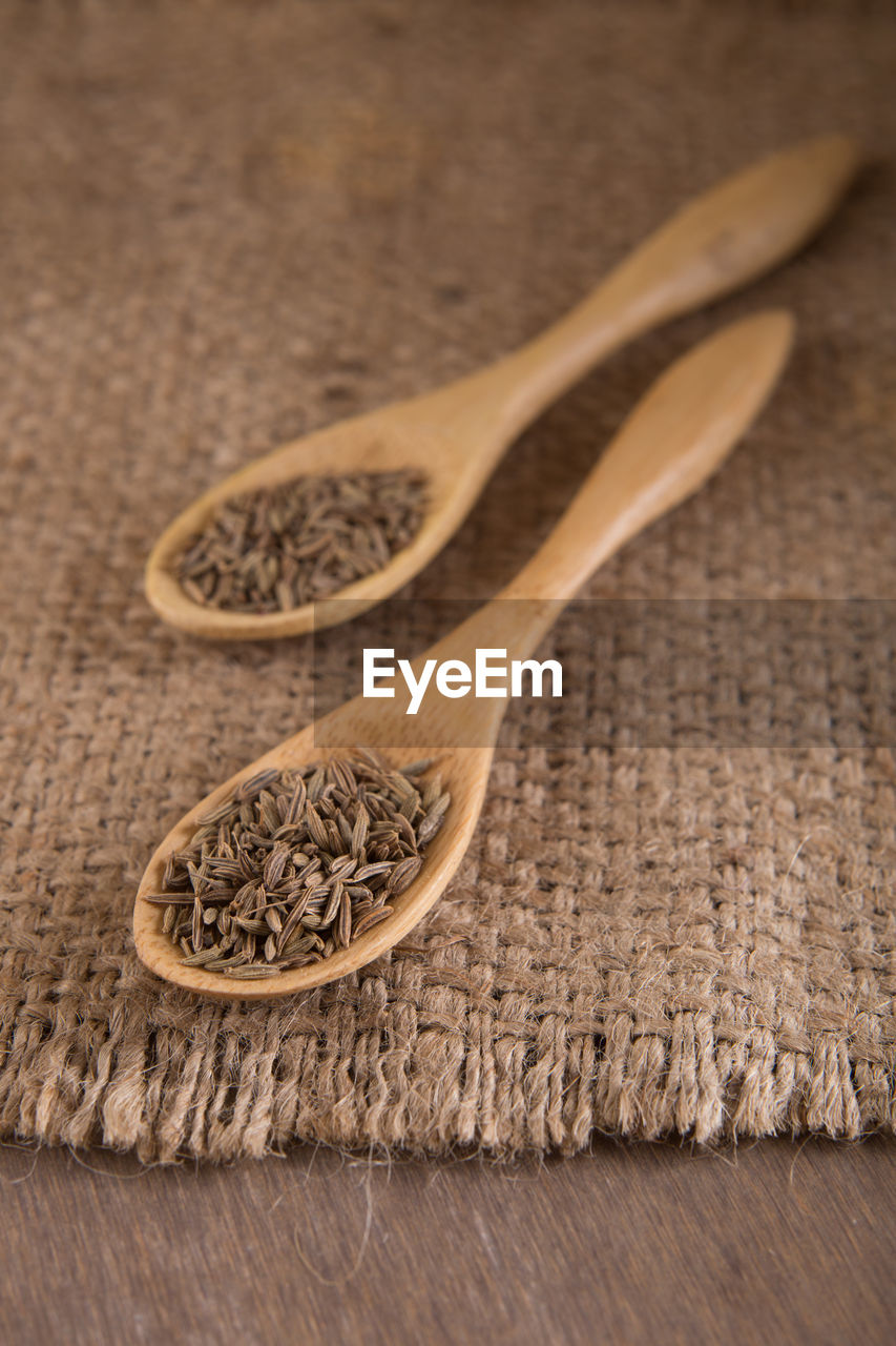 Close-up of ingredient in wooden spoon on table