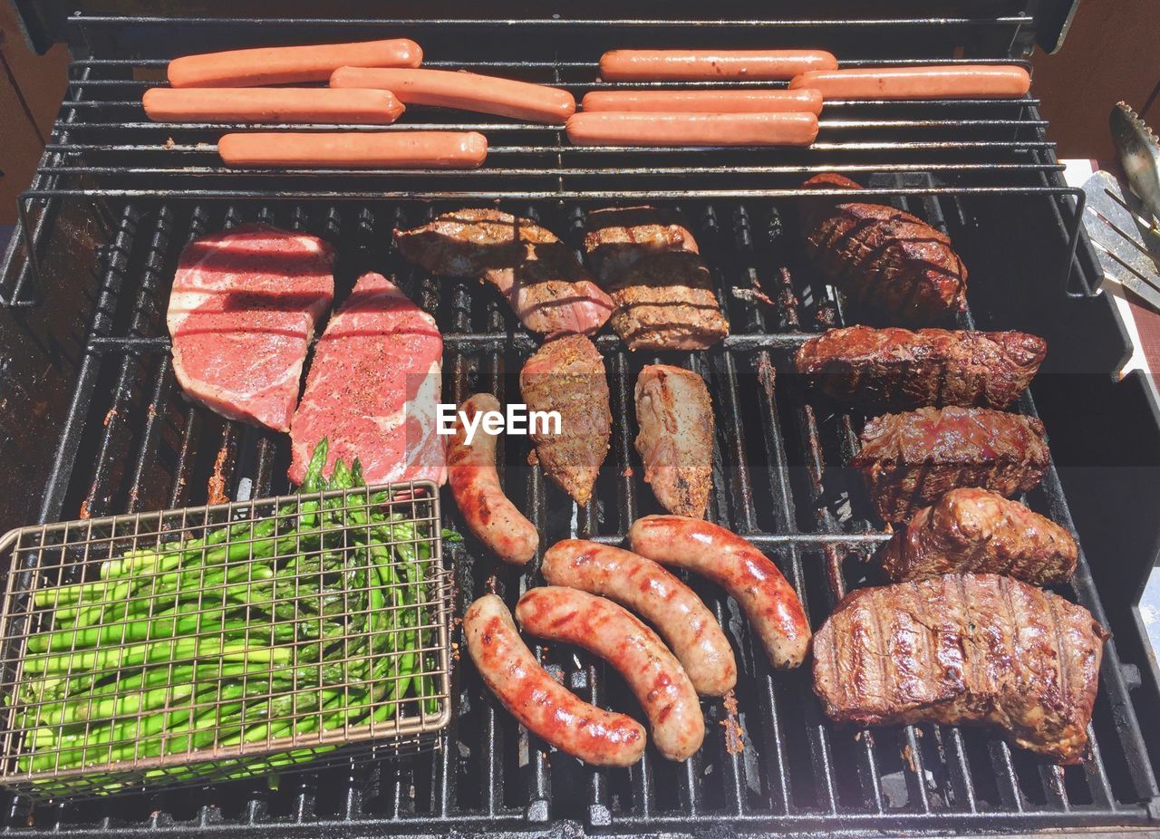 High angle view of meat on barbecue grill