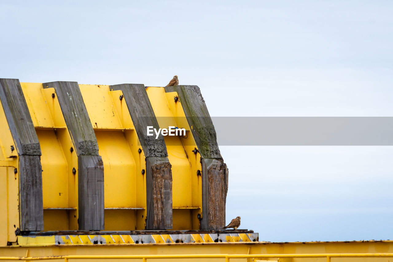 yellow, industry, construction equipment, sky, transport, transportation, nature, business, architecture, no people, outdoors, day, freight transportation, asphalt, copy space