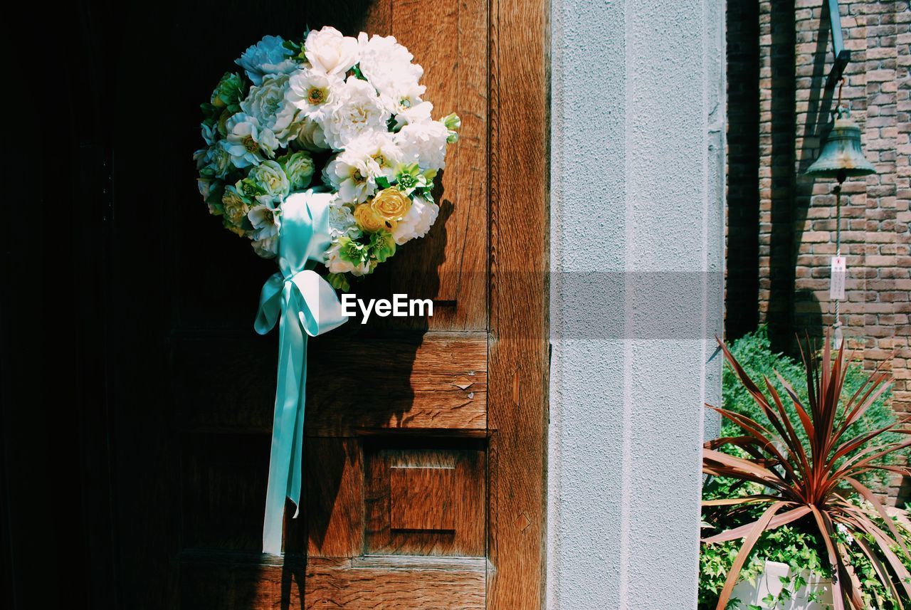 Close-up of flower wreath on door