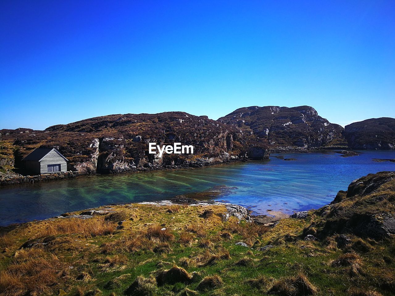 Scenic view of sea against blue sky