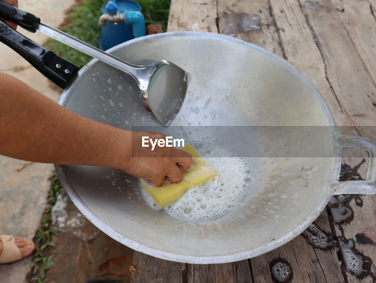High angle view of woman washing utensils on table