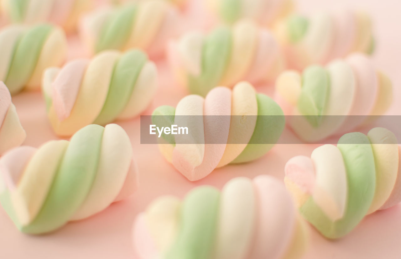 Colorful marshmallows composition on a pink background - copy space - children candies concept