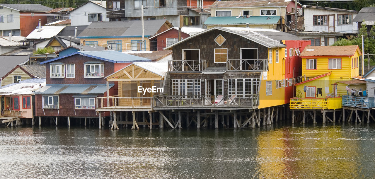 Buildings by river in city