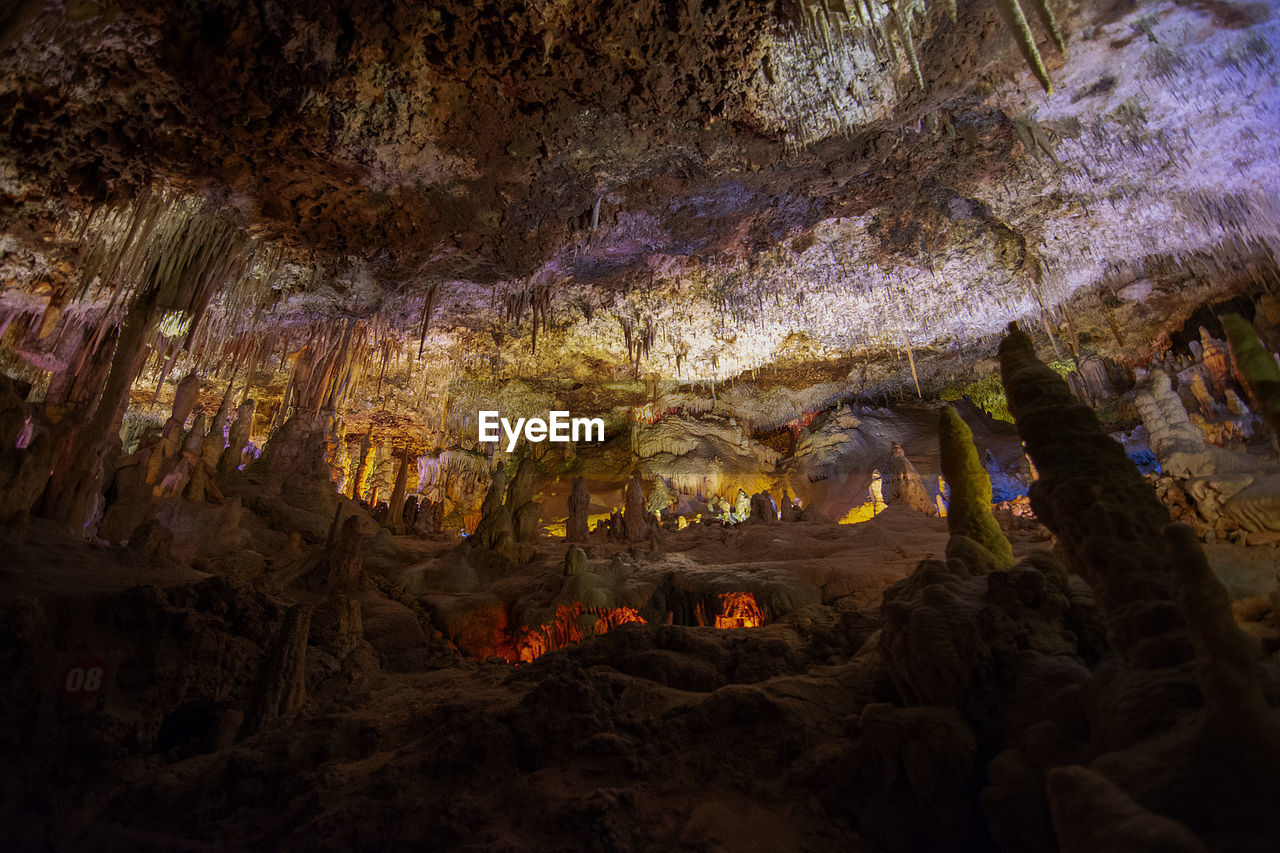 LOW ANGLE VIEW OF ILLUMINATED ROCK FORMATION