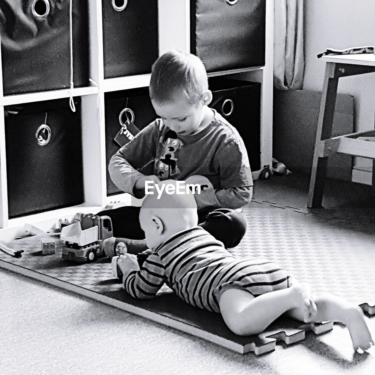 FULL LENGTH OF BOY SITTING ON SOFA