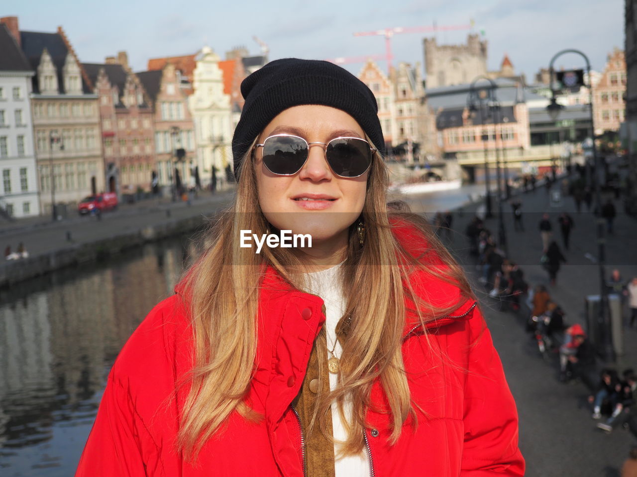 Portrait of smiling woman standing in city