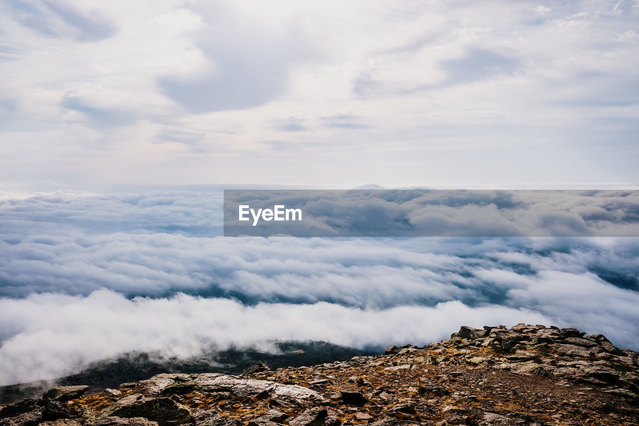 Scenic view of clouds over mountain against sky