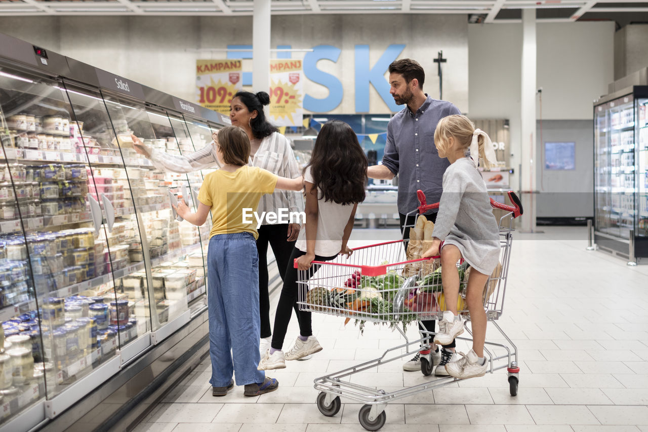 Family doing shopping in supermarket