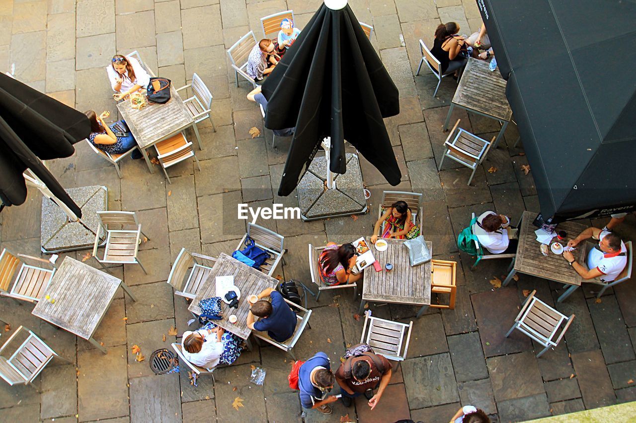 High angle view of people at sidewalk cafe