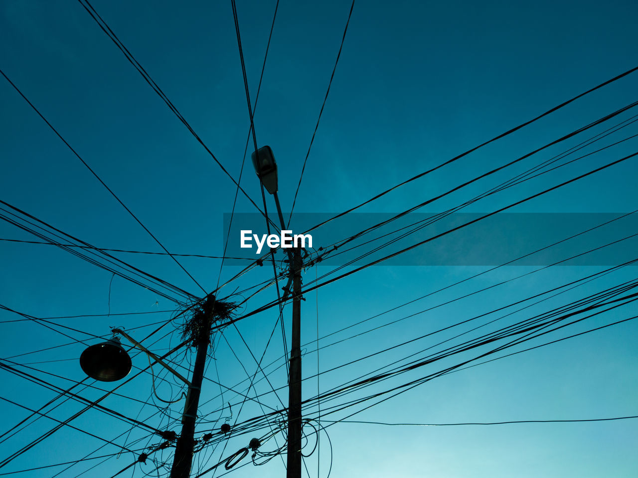 Low angle view of electricity pylon against sky