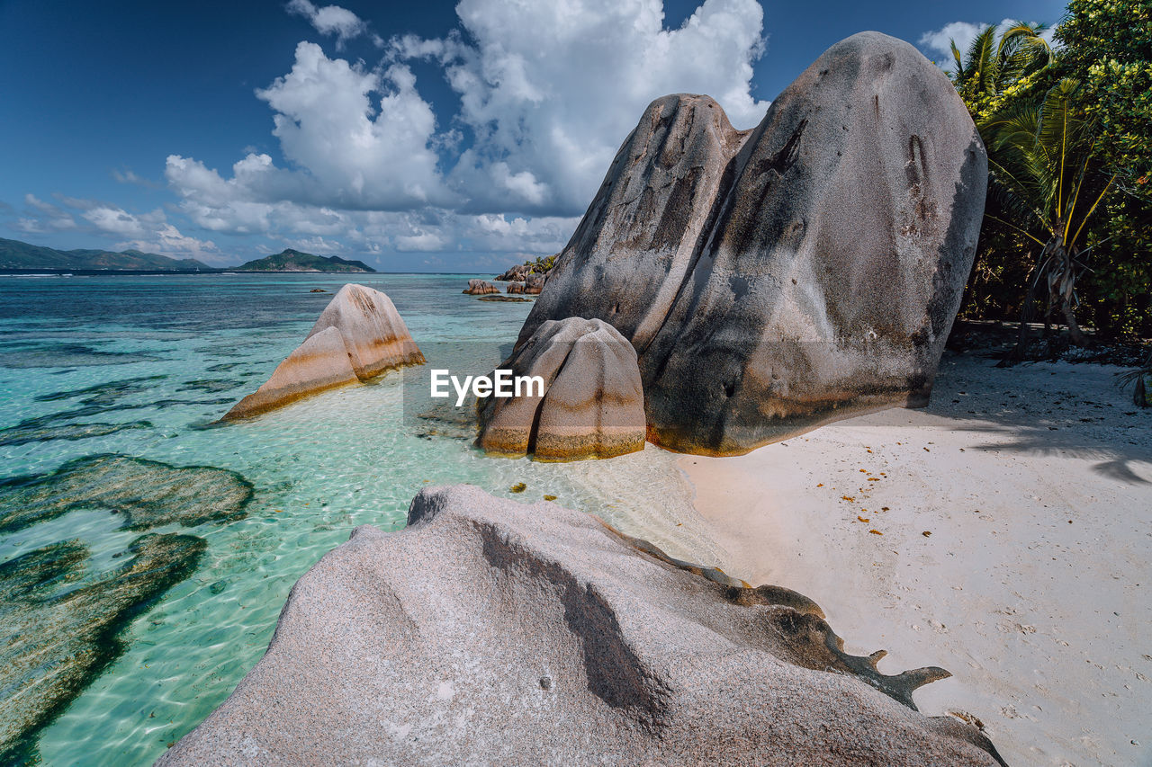 View of rocks on beach against sky