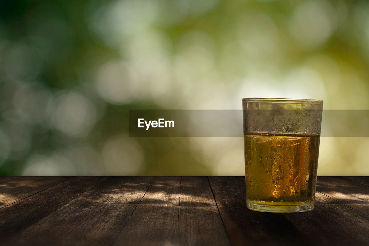 CLOSE-UP OF BEER ON TABLE