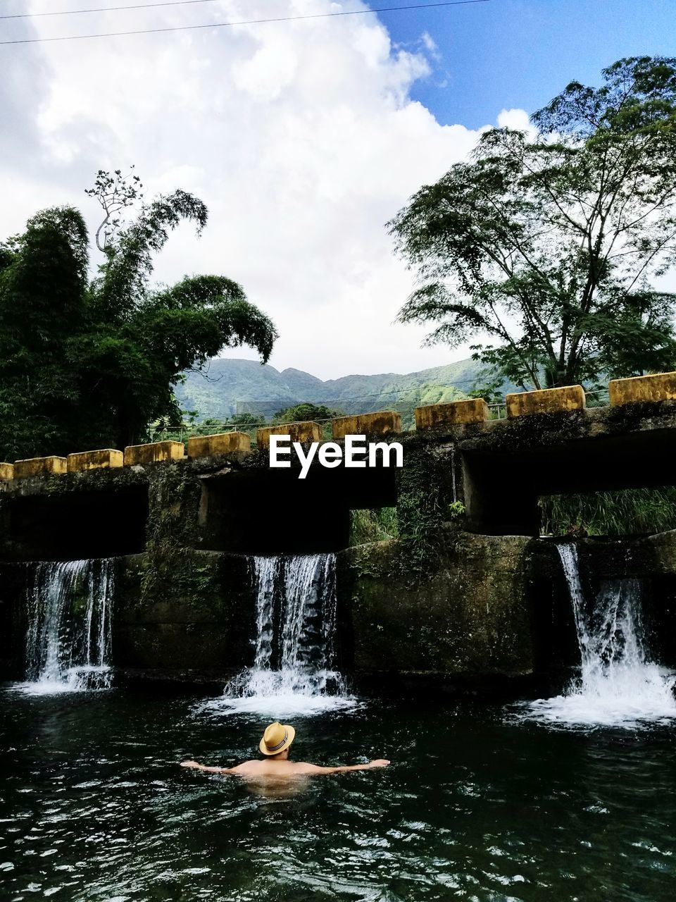 Scenic view of waterfall against sky