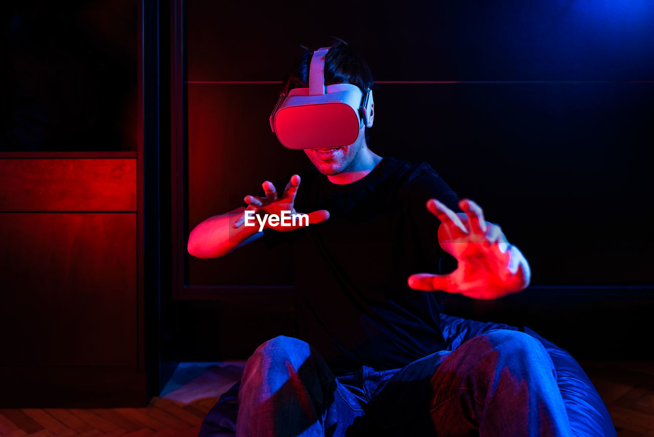 Gamer man wearing virtual reality goggles