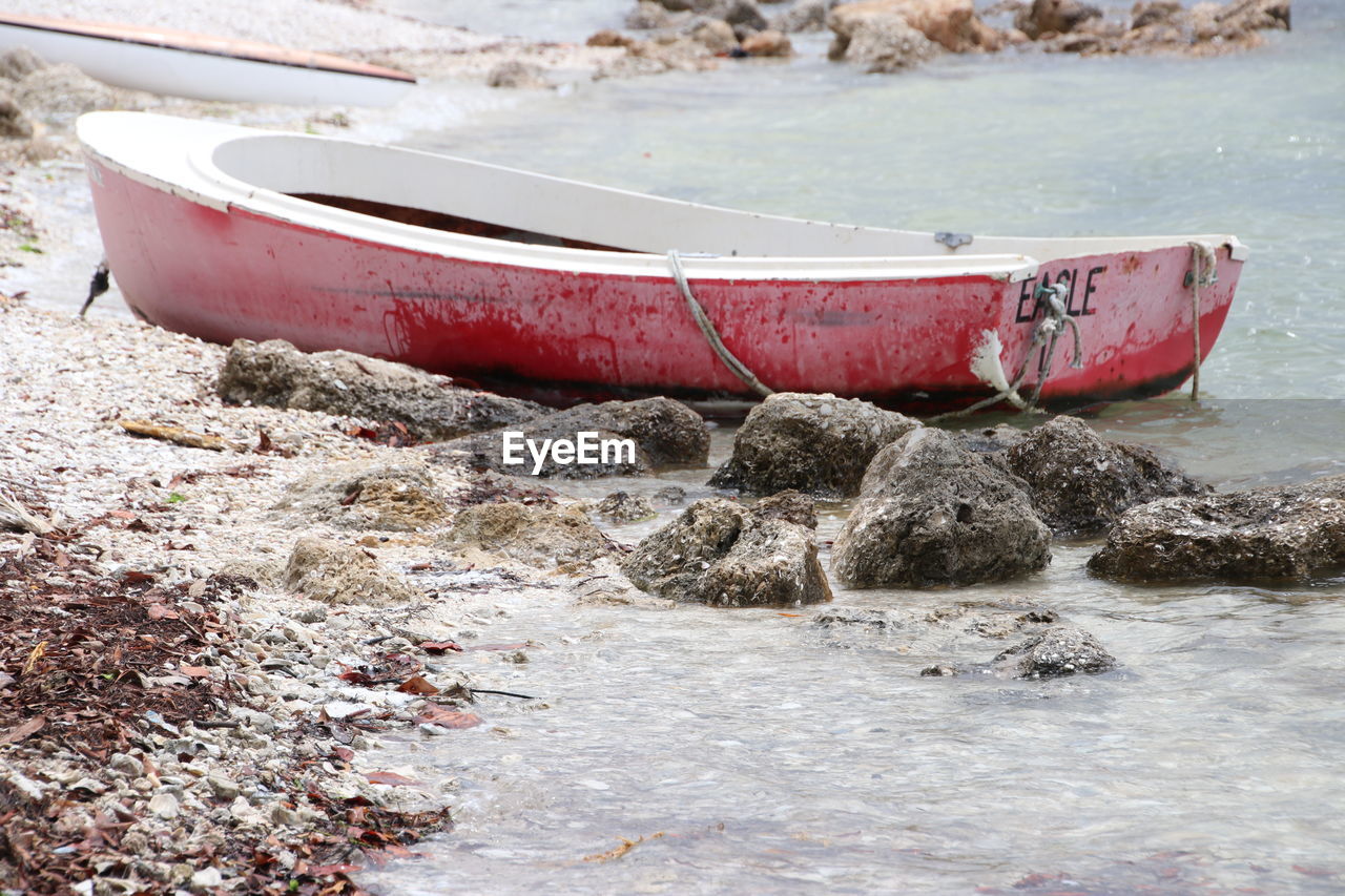 Abandoned boat moored on shore