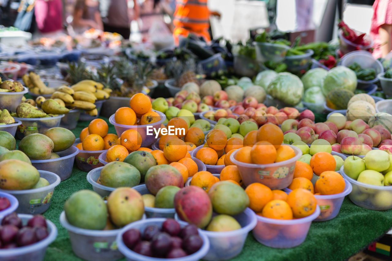 Fresh fruits for sale- oranges, apples, plums, pears and bananas.