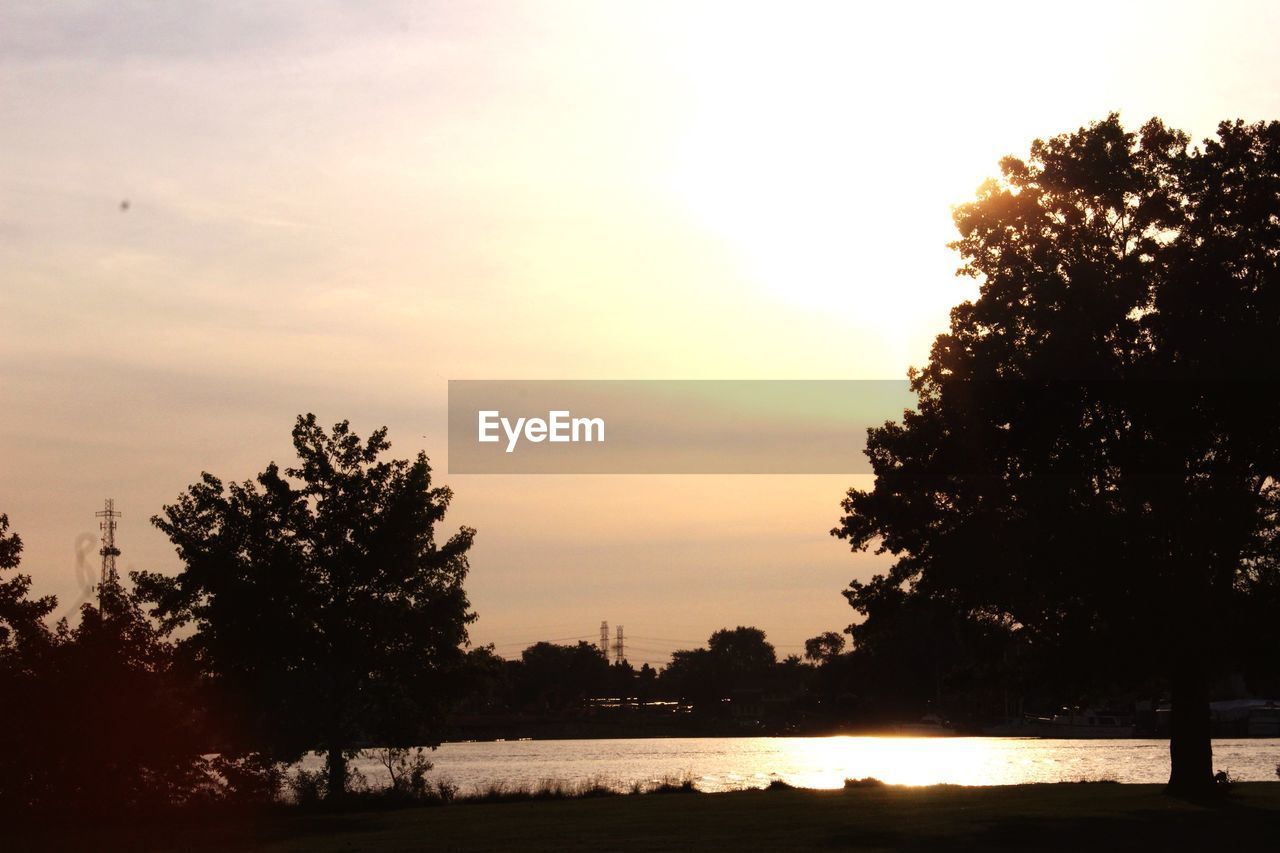 SCENIC VIEW OF LAKE AT SUNSET