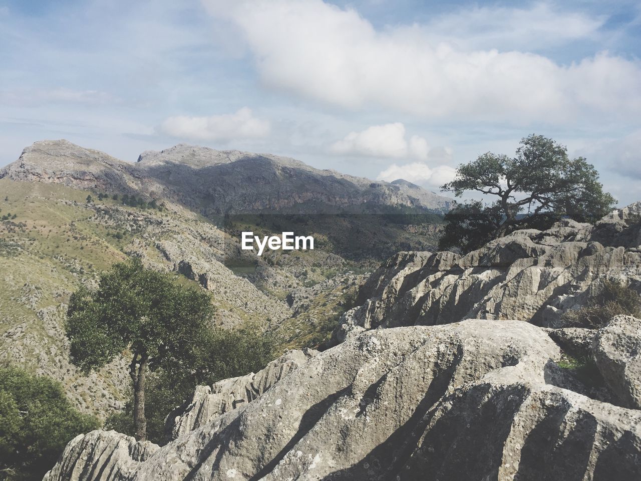 Rock formations at sierra de tramuntana against cloudy sky 