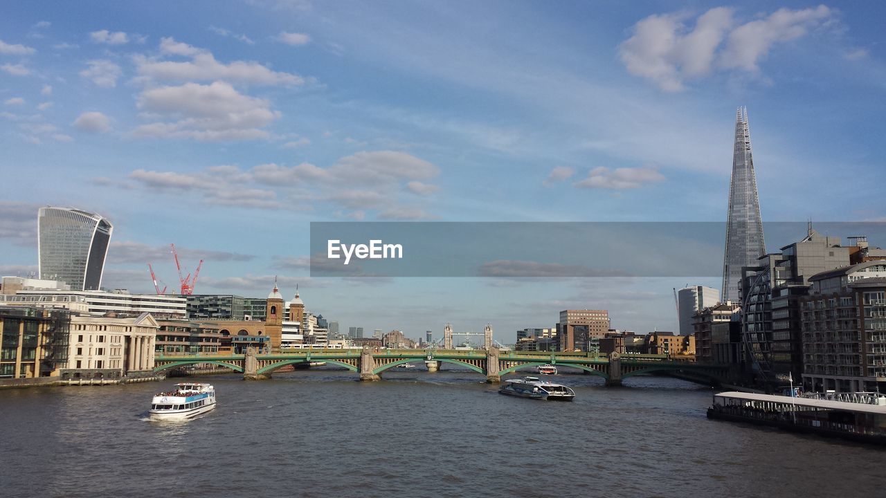 Boats in river with buildings in background