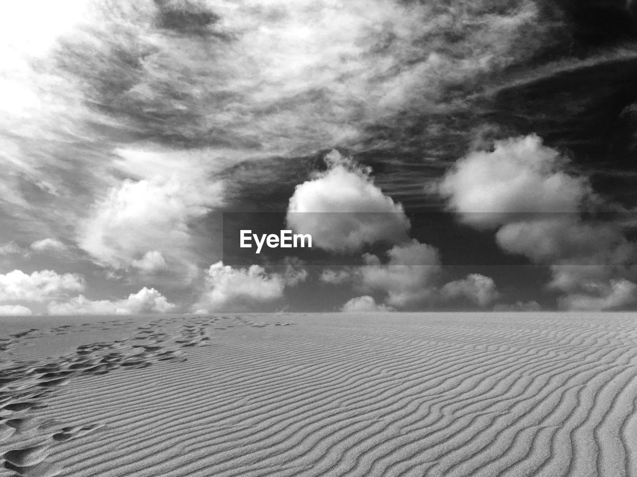 Scenic view of sand dune against sky