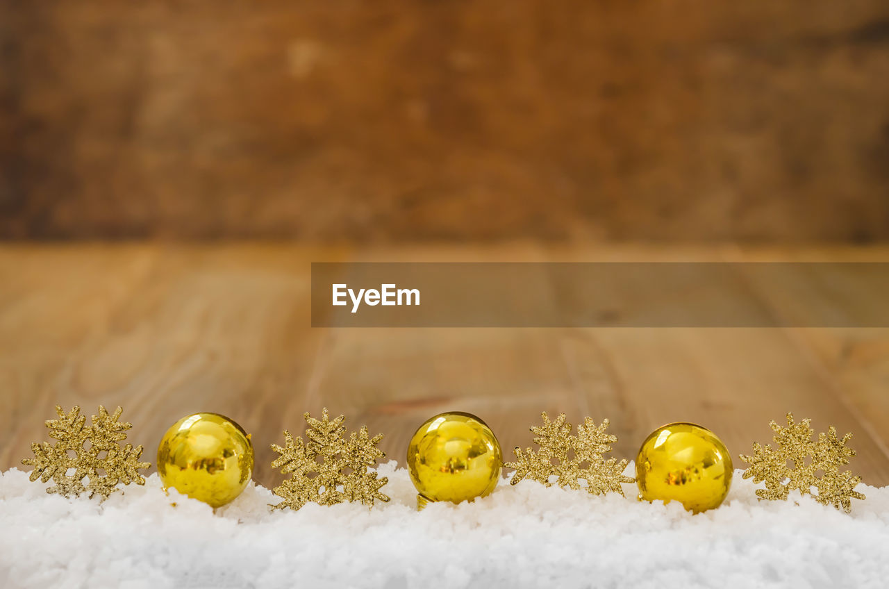 Yellow marbles on snow over table