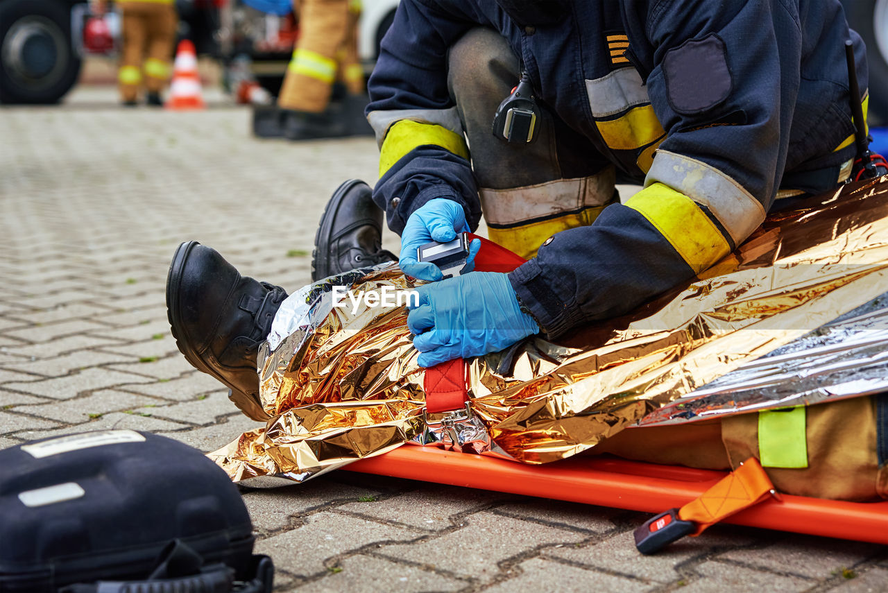 Rescuers provide first aid to the victim during car road accident