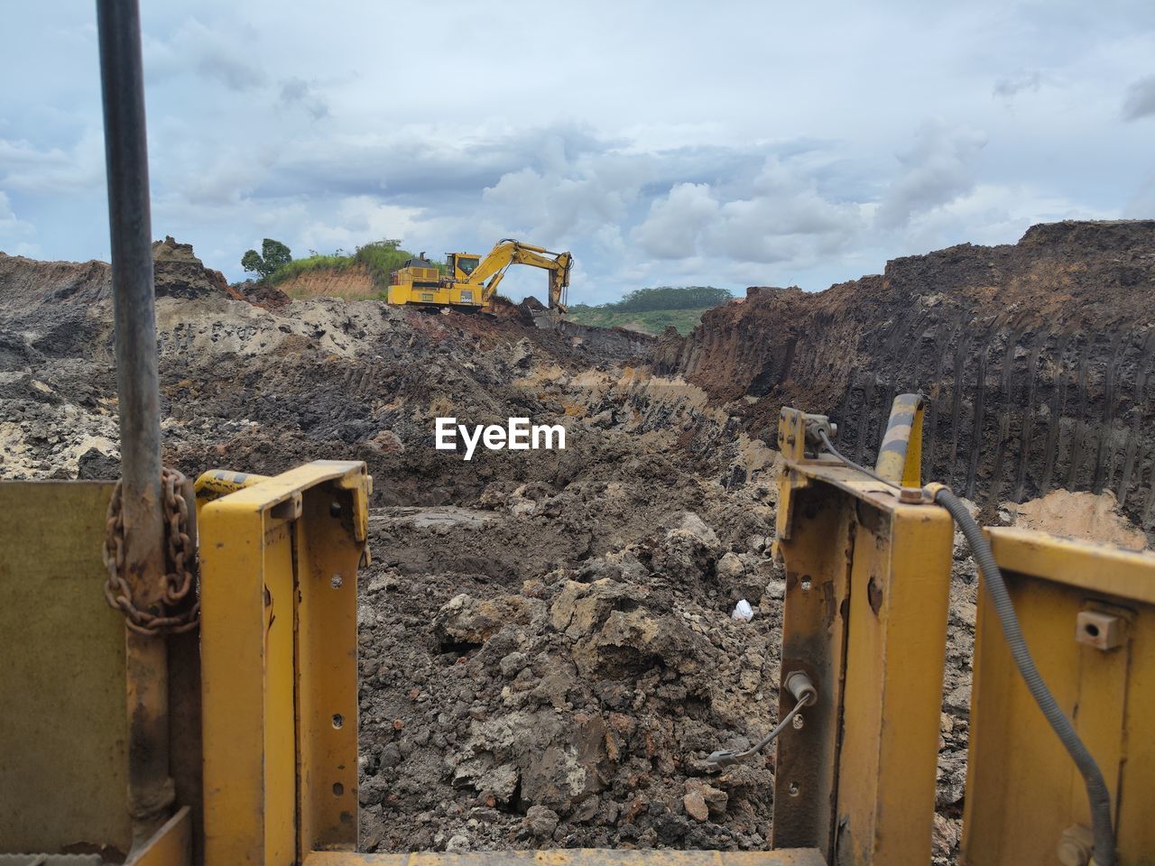 construction, cloud, industry, sky, environment, construction industry, nature, wall, no people, day, yellow, land, landscape, construction site, soil, outdoors, mountain, construction machinery, architecture, earth mover, transportation
